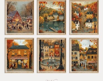 May include: Six framed art prints featuring autumnal village scenes. Each print showcases a different view, including a barn with string lights, a lakeside town, and bustling streets. The artwork is rendered in warm tones of orange, brown, and yellow.