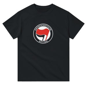 May include: Black t-shirt with a white circle containing a red fist and the text "Antifa Schistische Aktion".