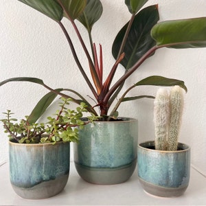 Reactive glaze, turquoise, and gray planter comes in three different sizes