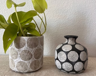 Terra cotta Planter or vase with wax relief dots. Planter comes in natural and white and is 4 3/4”R x 4 3/4” H.  Vase is black and natural 4