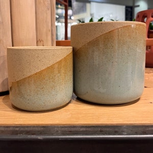 Reactive glaze, blue, and sand  colored ombré planter. Available in 2 sizes. 3 3/4”x 3 3/4” and 4 3/4” x 4 3/4”