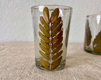 Hand blown glass votive with embedded leaf and gold leaf detail