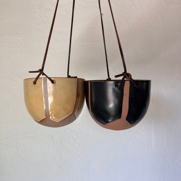 Hand painted rustic finished hanging planter  with leather strap comes in 2 styles black and natural or mustard and natural . 5”D x 5”H.