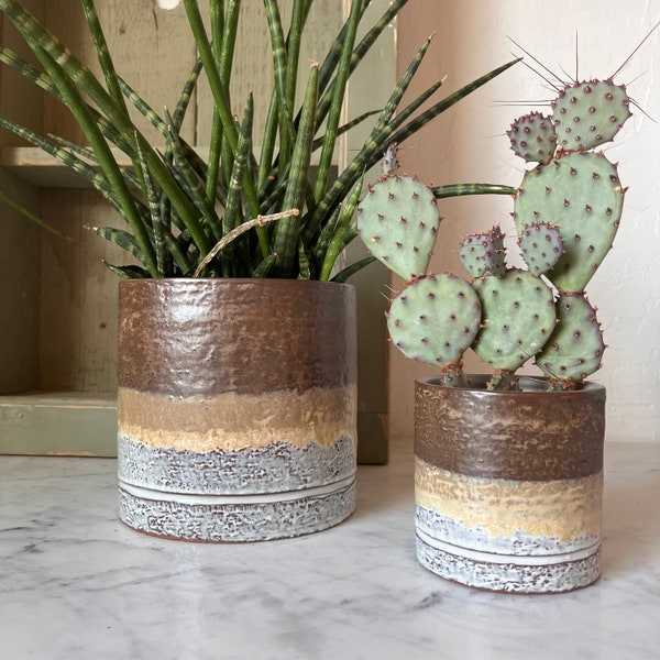 reactive glaze, brown, and white ombré planter. Available in 2 sizes. Holds a 3” and 5” pot