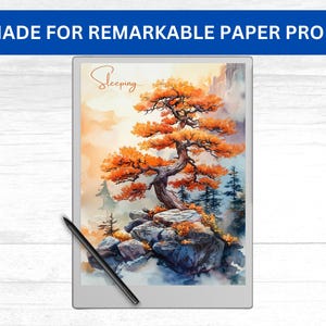 Puede incluir: Un dibujo digital de un árbol con hojas naranjas en un acantilado rocoso. El dibujo está en una tableta blanca con un lápiz negro a su lado. La tableta tiene el texto "Sleeping..." en ella. La tableta está etiquetada "Made for Remarkable Paper Pro".