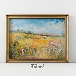May include: A painting of a field of wildflowers in a gold frame. The field is a mix of yellow, green, and pink flowers. The sky is blue with white clouds. The painting is titled "BOTANICA PRINT SHOP".
