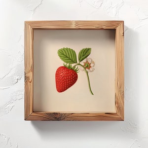May include: A framed illustration of a single red strawberry with green leaves and a white flower. The frame is made of natural wood with a rustic finish.