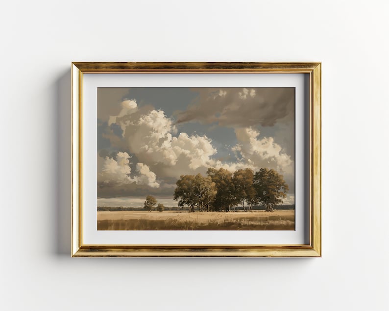 May include: A framed landscape painting depicting a field with a group of trees in the foreground and a cloudy sky above. The painting is in a gold frame.