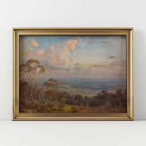 May include: A framed landscape painting depicting a view of a valley with rolling hills and trees under a cloudy sky. The painting is in a gold frame.