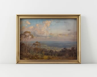 May include: A framed landscape painting depicting a view of a valley with rolling hills and trees under a cloudy sky. The painting is in a gold frame.