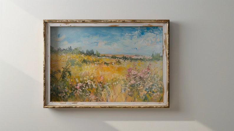 May include: A framed painting depicting a landscape with a field of wildflowers in shades of yellow, pink, and white. The sky is blue with white clouds. The painting is in a rustic, white-washed frame.
