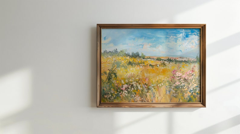 May include: A framed oil painting depicting a landscape scene with a field of wildflowers in the foreground, a forest in the background, and a blue sky with white clouds.