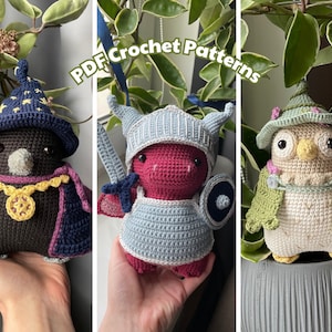 May include: Three crocheted amigurumi toys: a black crow wearing a blue wizard hat, a red dragon wearing blue and white armor, and a white owl wearing a green hat and a green cape. The toys are all holding props, such as a sword, a shield, and a wand. The image includes the text "PDF Crochet Patterns".