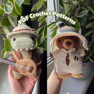 May include: Two crocheted dolls are displayed. One is a green dinosaur with a hat and banjo. The other is a brown bear wearing a hat and a bee pin. The text "PDF Crochet Patterns" is visible.