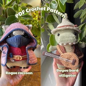 May include: Two crocheted amigurumi toys, a raccoon wearing a red hooded cloak and a green alligator wearing a brown hat and holding a lute. The text "PDF Crochet Pattern" is above the toys and the text "Rogue raccoon" is below the raccoon and "Bayou bard alligator" is below the alligator.