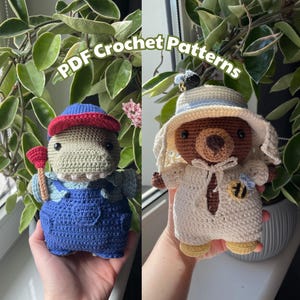 May include: Two crocheted amigurumi toys. One is a brown bear wearing a white hat and a white outfit with a bee design. The other is a gray dinosaur wearing a red hat and blue overalls with a wrench. The text "PDF Crochet Patterns" is written across the top of the image.