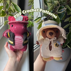 May include: Two crocheted stuffed toys, a red dragon wearing a firefighter hat and a brown bear wearing a white hat with a bee design. The toys are held in the hands of a person. The image includes the text "PDF Crochet Patterns".