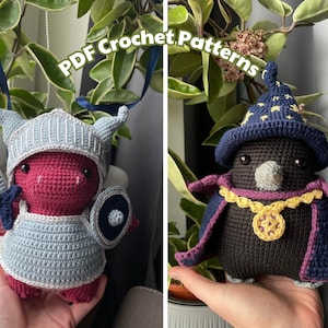 May include: Two crocheted amigurumi toys, a red dragon wearing armor and a black raven wearing a wizard hat and a purple robe.  PDF Crochet Patterns.