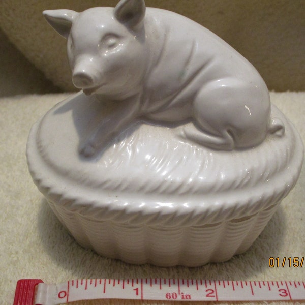Vintage porcelain pig on a basket trinket box