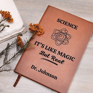 May include: A brown leather journal with the text "SCIENCE IT'S LIKE MAGIC But Real" and an atom symbol. The journal is personalized with the name "Dr. Johnson".