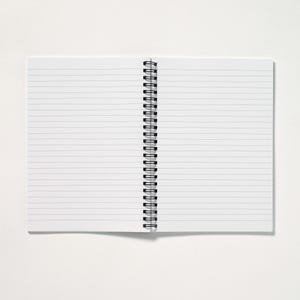 May include: An open, lined notebook with a black spiral binding. The pages are white with horizontal gray lines. The notebook is on a white surface.