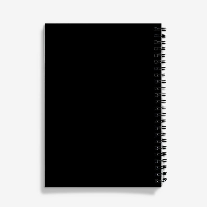 May include: A black spiral bound notebook with a blank cover.