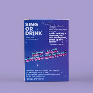 May include: A party game box titled "Sing or Drink: New Jack Swing Edition." The box is dark blue with white text and a retro design. It includes song lyrics and quotes from Johnny Kemp and Bobby Brown.