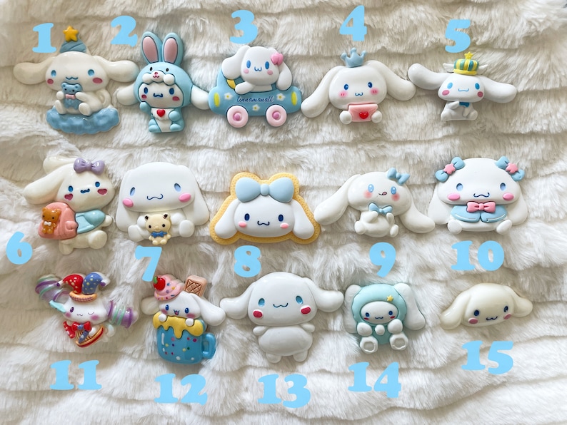 May include: Fifteen colorful, handmade, ceramic figurines of a cartoon dog character. The figurines are all different designs and feature various colors, including blue, pink, yellow, and white.