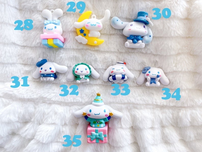 May include: A collection of ten small, white, ceramic figurines of a cartoon dog wearing different outfits. The dog is wearing a blue hat, a green dress, a blue and white striped life preserver, a blue bow, a blue hat with a white top hat, a yellow crescent moon, a pink and blue gift box, a green and white Christmas tree hat, and a pink and blue gift box with a green and white Christmas tree hat.