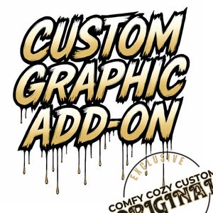 May include: A graphic design with the words "CUSTOM GRAPHIC ADD-ON" in gold lettering with black outlines and dripping effects. A circular logo at the bottom reads "COMFY COZY CUSTOM ORIGINAL DESIGN".
