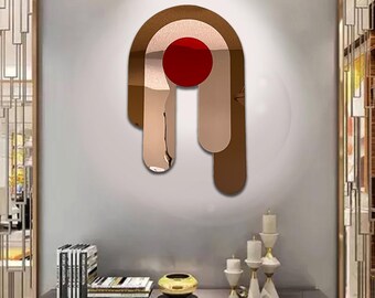 May include: A modern wall decor piece featuring a geometric design with a red circle in the centre. The design is made of metallic gold and has a dripping effect.