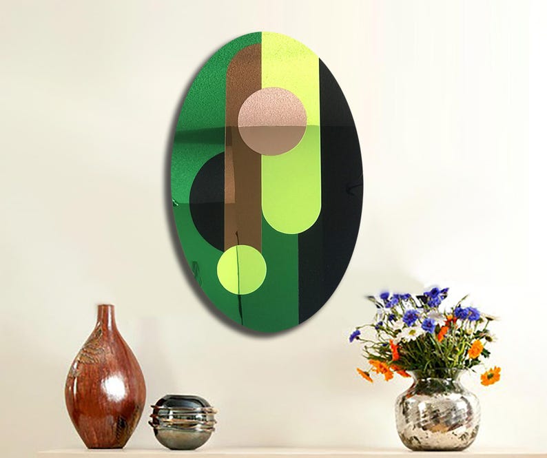 May include: A green, brown, black, and yellow abstract geometric design on a round canvas. The design features overlapping circles and stripes.