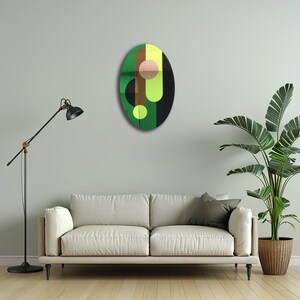 May include: A green, black, yellow, and brown abstract oval wall art piece with geometric shapes.
