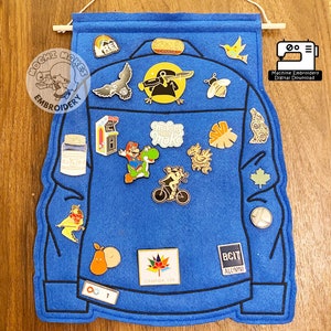 May include: Blue felt pin display shaped like a denim jacket with various pins attached, including a mushroom, a maple leaf, a video game character, and a bee. The text "Pin Jacket Display ITH 5x7 6x10" is at the top of the image. The text "Machine Embroidery Digital Download" is in the bottom right corner of the image.