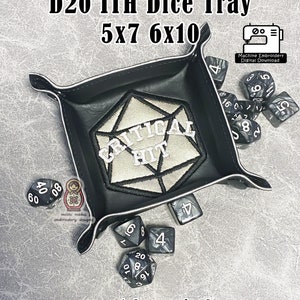 May include: Black D20 ITH dice tray with a white stitched "CRITICAL HIT" design. The tray has a white border and contains dice. The image text reads "D20 ITH Dice Tray 5x7 6x10" and "-snap tabs required-".