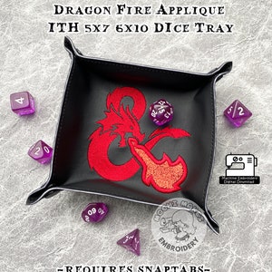 May include: A black leather dice tray with a red dragon fire applique. The tray is 12.7cm x 17.8cm and 15.2cm x 25.4cm. The tray is designed for role-playing games and includes the text "Dragon Fire Applique" and "ITH 5x7 6x10 Dice Tray".