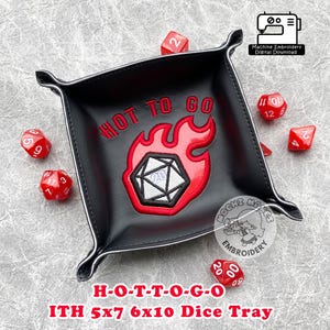 May include: A black leather dice tray with a red embroidered flame design and the text "HOT TO GO". The tray is 5 inches by 7 inches and 6 inches by 10 inches. It is designed for use with role-playing games.