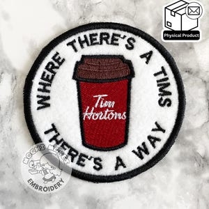 May include: Circular embroidered patch with a red Tim Hortons coffee cup design. The patch has the text "WHERE THERE'S A TIMS THERE'S A WAY" in black around the edge. The patch is a physical product.