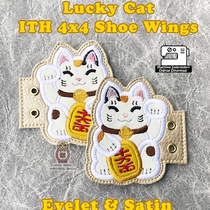 May include: A pair of white and gold lucky cat shoe wings with eyelet and satin stitching. The wings are designed for 4x4 inch embroidery hoops and are available as a digital download.