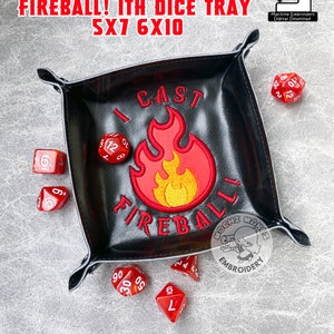 May include: Black leather dice tray with red and yellow embroidered flames and the text "I Cast Fireball!"  The tray is 12.7cm x 17.8cm and 15.2cm x 25.4cm.  It requires snap tabs.  There are several red dice scattered around the tray.