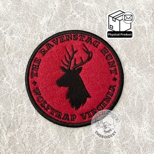 May include: Red embroidered patch with black stitching featuring a deer silhouette and the text "The Ravenstag Hunt Wolf Trap Virginia".