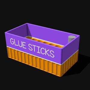 May include: A rectangular purple and orange storage container with the text GLUE STICKS printed in white on the front. The container features a ribbed orange base and a smooth purple top section with multiple circular openings for holding items.