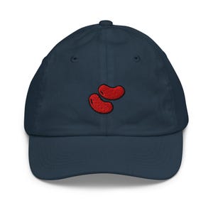 May include: A navy blue baseball cap with red embroidered jelly beans on the front.
