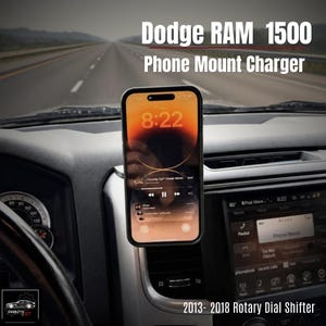 May include: A phone mounted in a Dodge RAM 1500, showing the time 8:22. The phone is mounted on the dashboard, with the text "Phone Mount Charger" and "2013-2018 Rotary Dial Shifter" visible. The car's interior is visible.