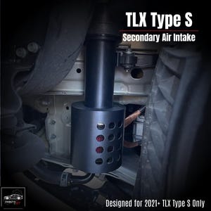 May include: Black secondary air intake system for TLX Type S vehicles. The cylindrical component features a perforated lower section with a red filter visible inside. The text "TLX Type S Secondary Air Intake" is displayed at the top, with "Designed for 2021+ TLX Type S Only" at the bottom.