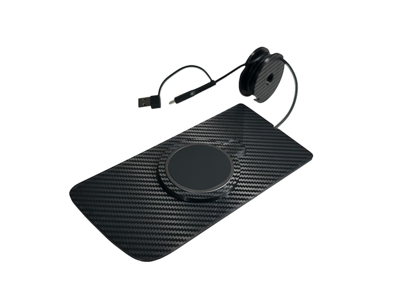 May include: A black wireless charging pad with a carbon fiber pattern. The pad has a circular charging area and a USB cable. A black cable spool is attached to the pad.