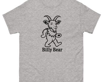 May include: A heather gray t-shirt featuring a black graphic of a goat-like creature in a walking pose. The text "Billy Bear" is printed below the graphic in a bold, sans-serif font. The shirt has short sleeves and a crew neck.
