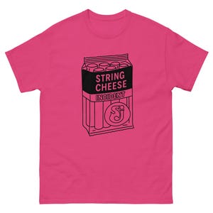 May include: A hot pink t-shirt featuring a black and white graphic of a string cheese package. The text on the package reads "STRING CHEESE INCIDENT" and includes a stylized "SJ" logo.