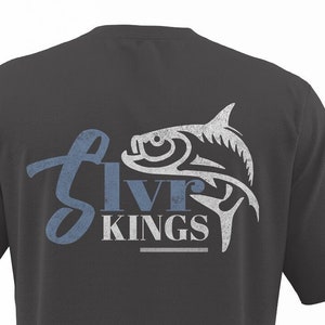 May include: A dark grey t-shirt with a white and blue graphic of a fish and the text "Silver Kings" on the back.