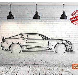 May include: Line art design of a black car, a Chevrolet Camaro, on a white brick wall background. Three black pendant lights hang from the ceiling above the car.